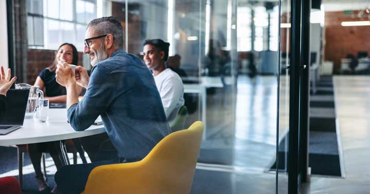 man sitting in meeting with cup of tea. Talk to Harrow-based RA Accountants about issues that could affect your payroll. Remember not all benefits need to be reported on Form P11D