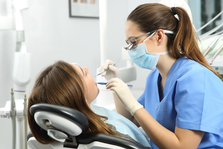 Dentist examining patient. RA Accountants are dental accountants in London. Come and see us at the London Dentistry Show.