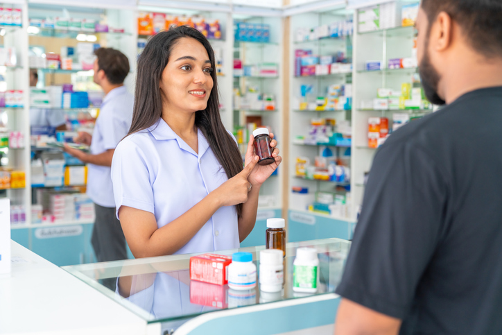 Pharmacist helping customer in Pharmacy. RA Accountants are an accountant for pharmacy businesses. Come and talk to us at the NEC Pharmacy Show.