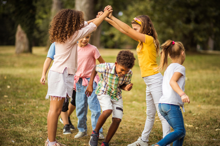 Large group of school kids having fun in nature. Read RA Accountants' blog "Back to school – set up a tax-free childcare account"