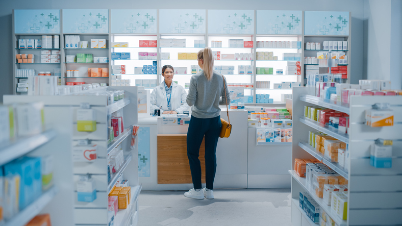 Pharmacist serving customer in pharmacy
