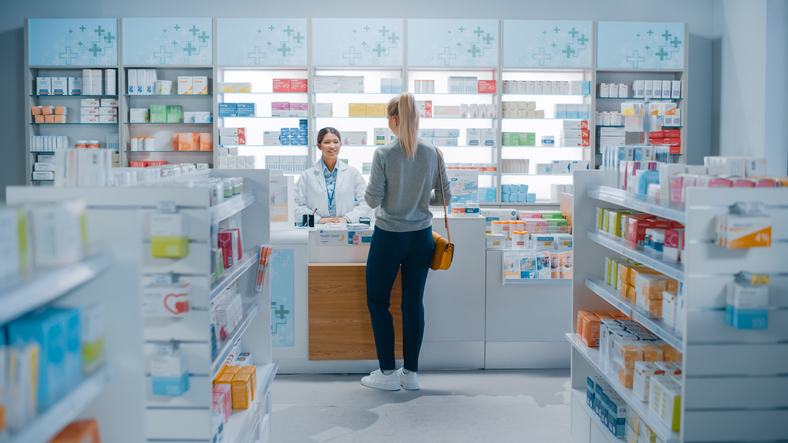 Pharmacist serving customer in pharmacy. Talk to the specialist accountant for pharmacy, RA Accountants about the financial aspects of running a successful pharmacy