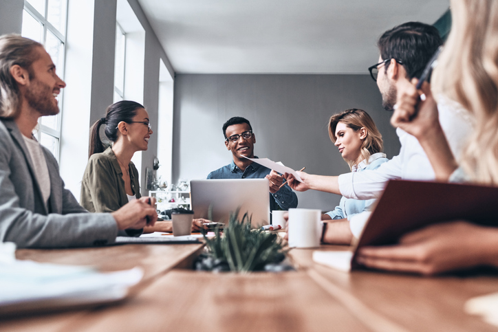 Group of young workers around table in office. Read our payroll update to see how the latest changes could affect your payroll.