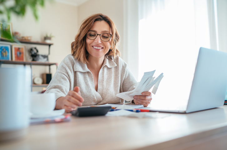 Woman using calculator