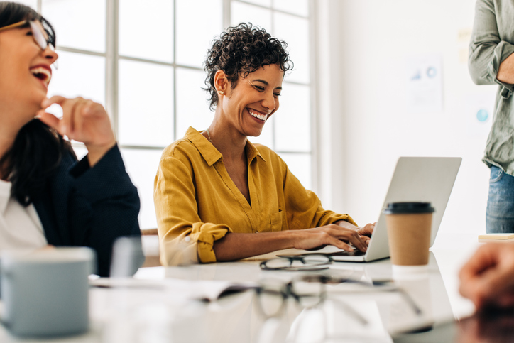 Woman in a meeting uses her computer