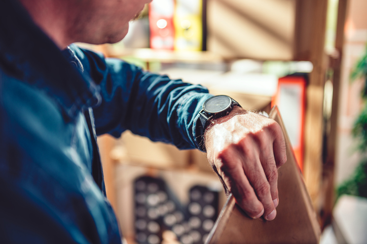 Man looking at wristwatch at the office