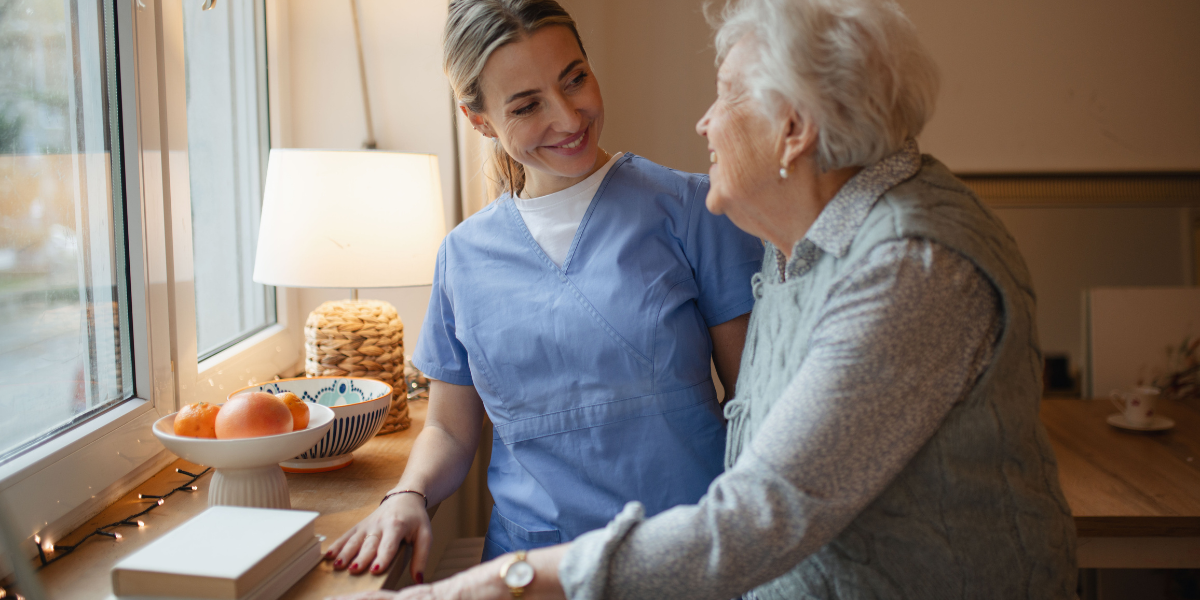 Care worker supporting an elderly resident in a care home